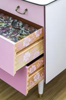 Open drawers showing stencilled pattern on the sides 