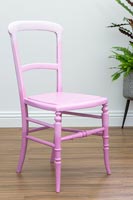 Chair painted to create an ombre paint effect with various shades of pink