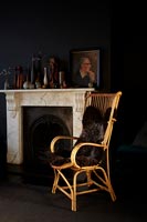 Wicker chair next to fireplace 