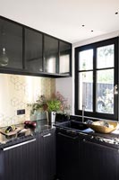 Modern black and white kitchen with cube patterns on wall 