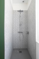 Grey tiling in modern shower cubicle 