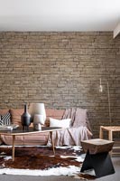 Exposed stone brick wall in modern living room 