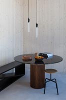 Small table and chairs in corner of contemporary living space 