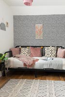 Patterned feature wall in modern bedroom with daybed 