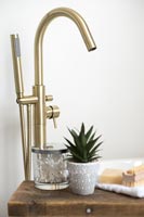 Gold mixer tap in modern bathroom 