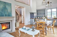 Open plan country living space with kitchen, dining and seating areas 