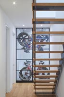 Contemporary open staircase with view of clever bike storage 