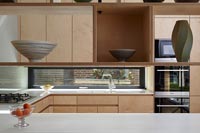 View of modern kitchen through floating shelves 