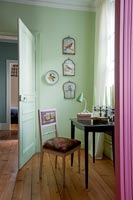 Green painted walls and pink curtains in bedroom 