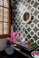 Black and white retro patterned wallpaper in modern bathroom 