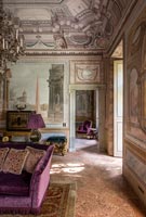Classic living room with frescoes on walls and ceiling 