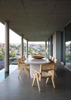 Outdoor dining area on modern concrete terrace with scenic views 