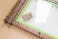 Rubbing down old wooden frame - memories notice board 