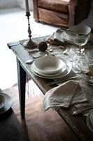 Detail of country dining table laid for dinner 