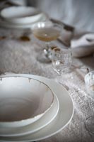 Detail of decorative glasses and crockery on dining table 