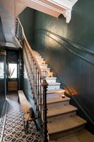 Classic staircase with dark green painted walls 