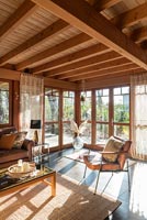 Country living room with sunshine pouring in through windows 