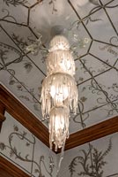 Patterned ceiling and drip effect chandelier 