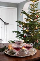 Drinks on silver tray with Christmas tree in background