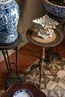 Detail of vases and ornaments on small round side tables 
