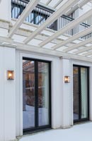 Exterior of patio doors with snow covered terrace 