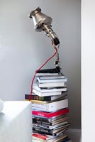Modern metal lamp on pile of books 