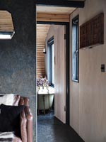 View into modern bathroom through open internal wooden doors 