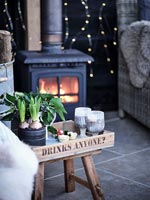 Lit wood burning stove in outdoor living area in winter 