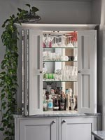 Drinks cabinet open to reveal mirrored shelving 