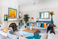 Modern living room with orange and blue accessories 