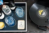 Portable record player and drinks tray on sideboard 