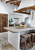 Modern country kitchen with textured pebble floor 