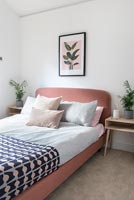 Modern bedroom with pink headboard 