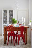 Red chairs around small wooden table in kitchen diner 
