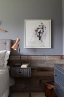Textured wooden wall in grey painted modern bedroom 