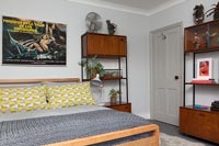Yellow and grey bedding and vintage furniture in modern bedroom 
