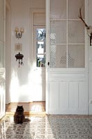 Decorative tiling and doors in country hallway 
