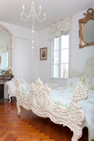 Classic bedroom with ornate bedframe 