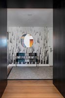 Patterned wall and seat in contemporary hallway 