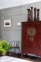 Wooden cabinet against panelled wall