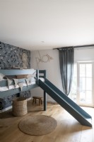 Childrens room with wallpaper and bunkbed with slide