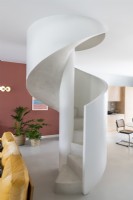 Rendered spiral staircase in open plan modern living space 