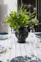 Flower and foliage arrangement on country dining table - detail