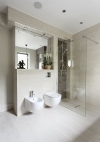 Contemporary bathroom with shower cubicle toilet and bidet