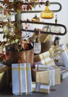 Christmas presents under vintage glassware and leaf decoration