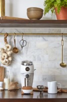 Coffee grinder and utensils on modern kitchen worktop