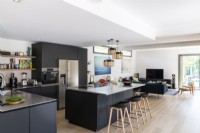 Black kitchen in  modern open plan living space 