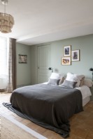 Country bedroom with black bedding and green painted wall