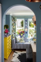 View through arched doorway to colourful living area
