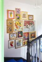 Display of eclectic artwork over staircase